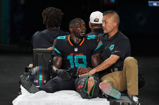 Dolphins’ Tyreek Hill carted off field and taken to hospital with dislocated left knee