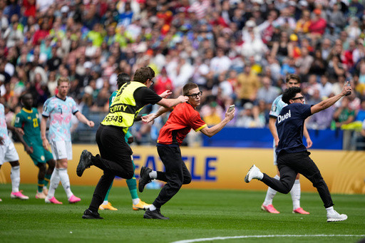 Three people run onto field and stop play during the World Cup match between Belgium and Senegal