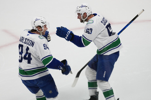Boeser has hat trick, last-place Canucks overcome blowing 4-goal lead to beat NHL-leading Avs 8-6