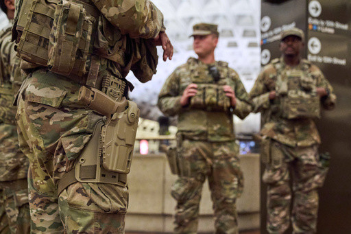 Photos of week three of Washington’s federal takeover, as troops on patrol start carrying guns