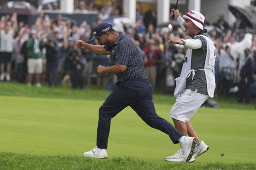 A caddie at heart, Bones Mackay makes sure to get the 18th flag to Spaun’s bagman