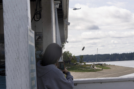 Flying boats make for a rare sight as Washington clears an island of derelict vessels by helicopter