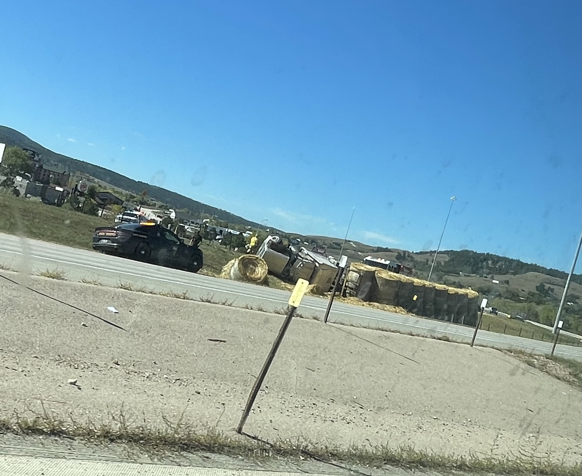 Truck full of hay rolls over on I-90 at Sturgis