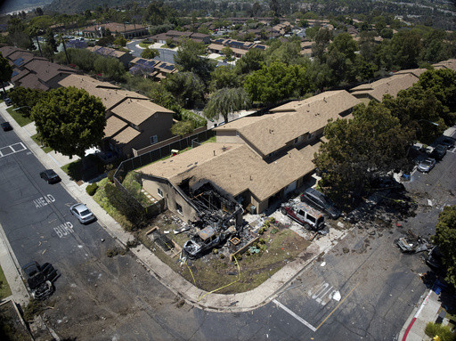 AP PHOTOS: Jet crashes into San Diego neighborhood, killing 3 and setting homes and vehicles on fire