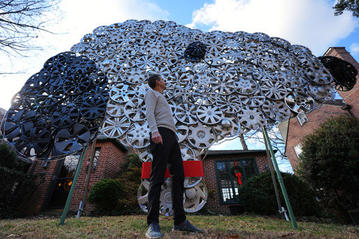 Baltimore cyclist finds joy in collecting lost hubcaps and stringing them into art