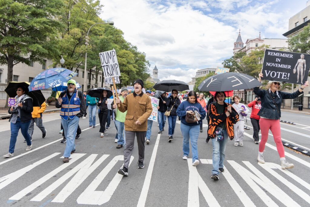 In the nation’s capital, rallygoers hoist umbrellas at No Kings get-out-the-vote event