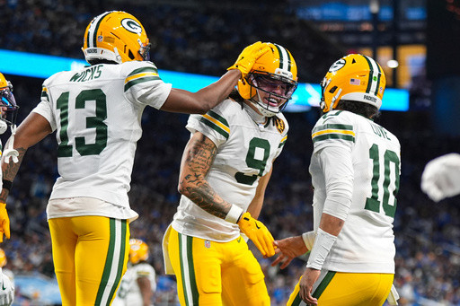 Love matches career high with 4 TD passes, lifting Packers to 31-24 win over Lions