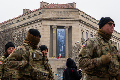Large banner featuring Trump’s face is displayed on Justice Department headquarters